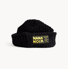 Front view of CHECK IN black crochet beanie with oversized cuff and yellow Nana Noir patch