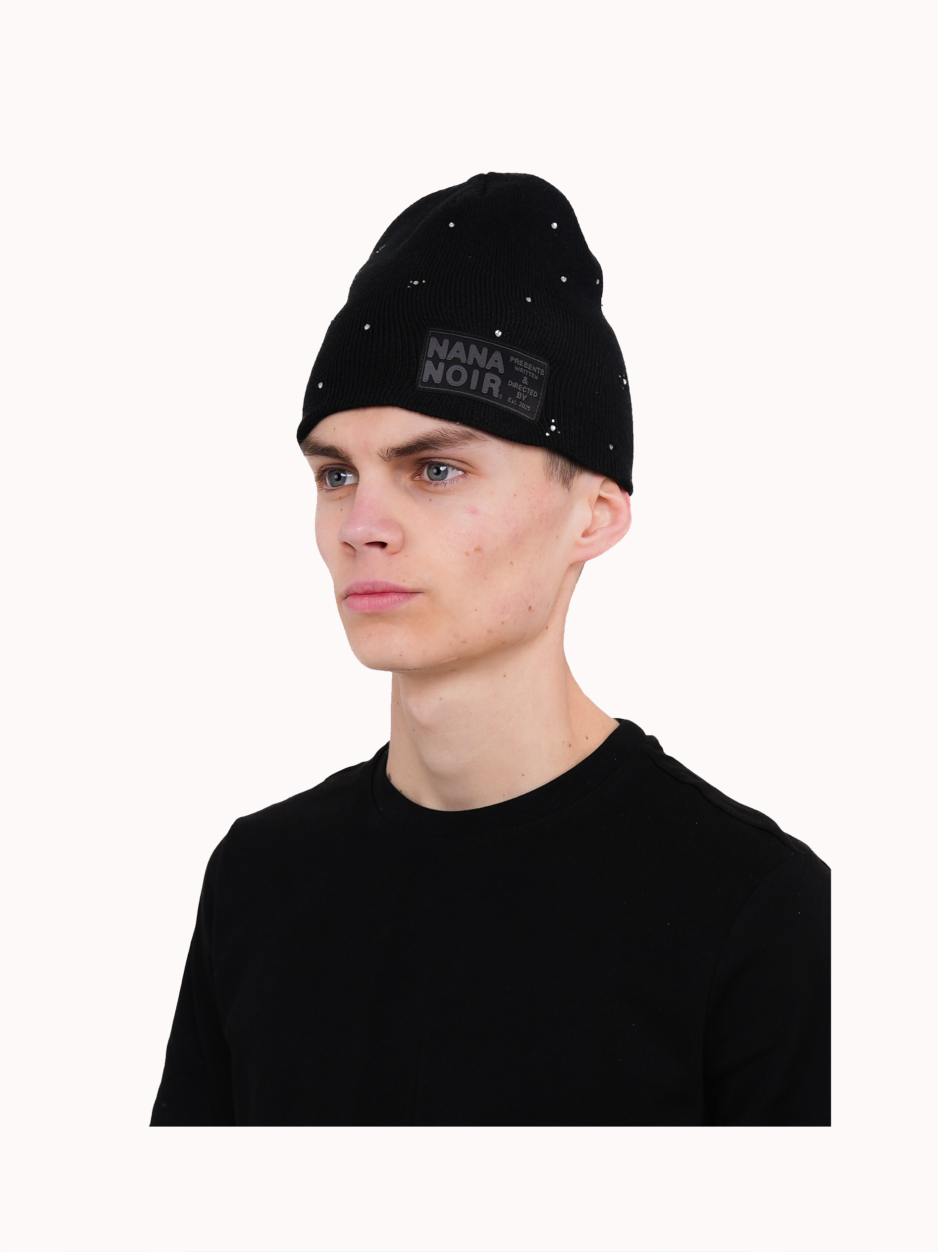 Model wearing the BACK HOME black ribbed beanie with silver studs and Nana Noir patch